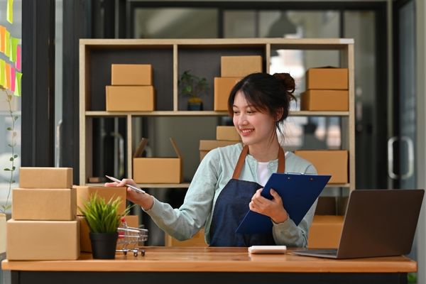 a shipping store owner smiling while working